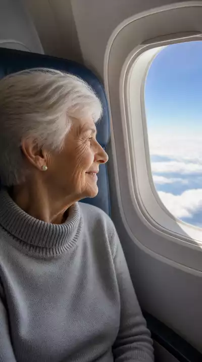 Senior woman looking out airplane window, enjoying the view